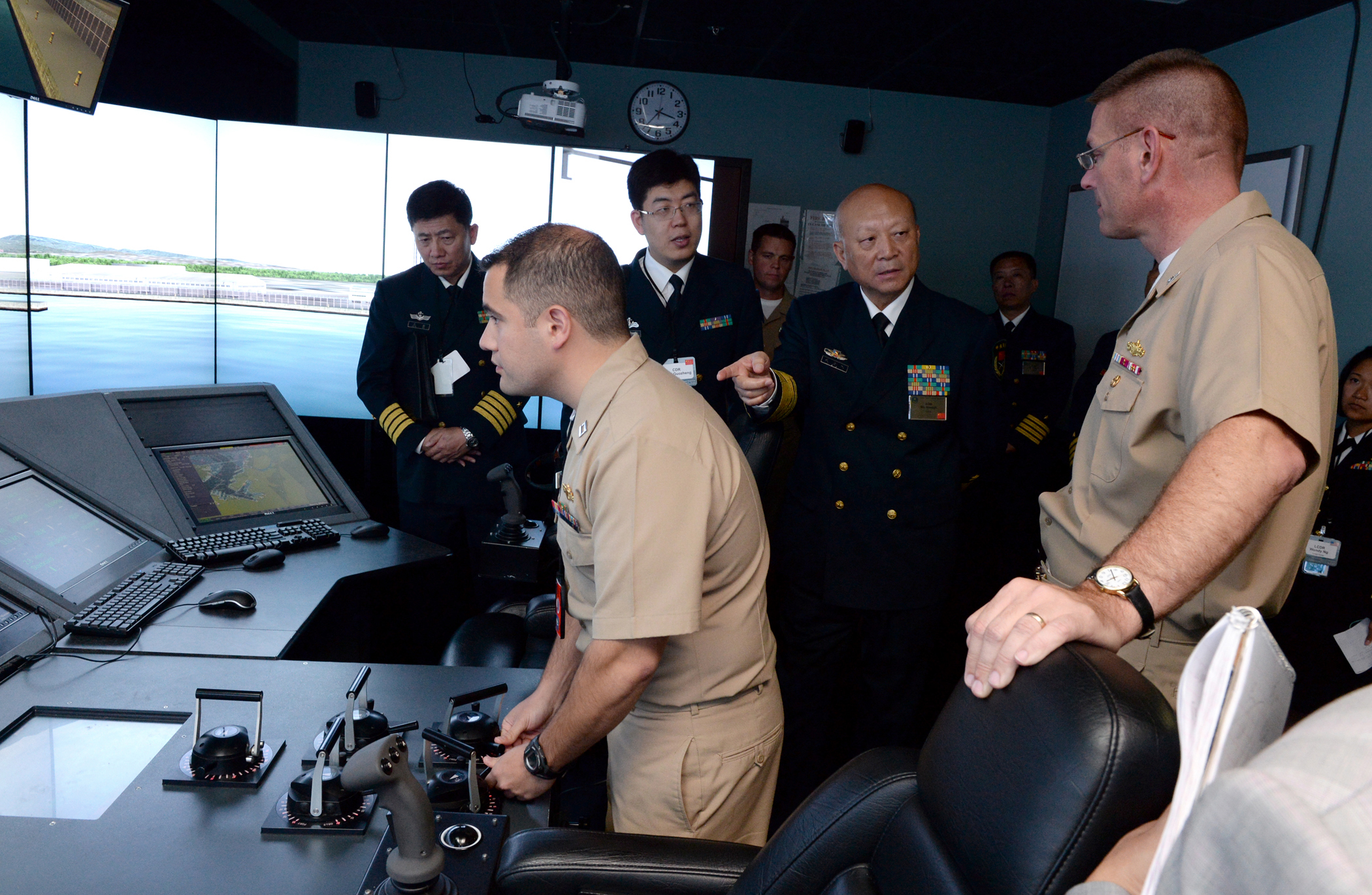 140918-N-PX557-211 NEWPORT, R.I. (Sept. 18, 2014) Capt. Dave Welch (right), commanding officer, Surface Warfare Officers School (SWOS), provides a tour for Commander in Chief of the People's Liberation army navy of the People's Republic of China Adm. Wu Shengli at the SWOS onboard Naval Station Newport in Newport, Rhode Island. SWOS provides a continuum of professional education and training in support of surface Navy requirements that prepares officers and enlisted engineers to serve at sea. Shengli is currently in Newport attending the Chief of Naval Operations’ 21st International Seapower Symposium at U.S. Navy War College. More than 170 senior officers and civilians from more than 100 countries, including many of the senior-most officers from those countries’ navies, are currently attending the biennial event Sept. 16-19. (U.S. Navy photo by Chief Mass Communication Specialist James E. Foehl/Released)