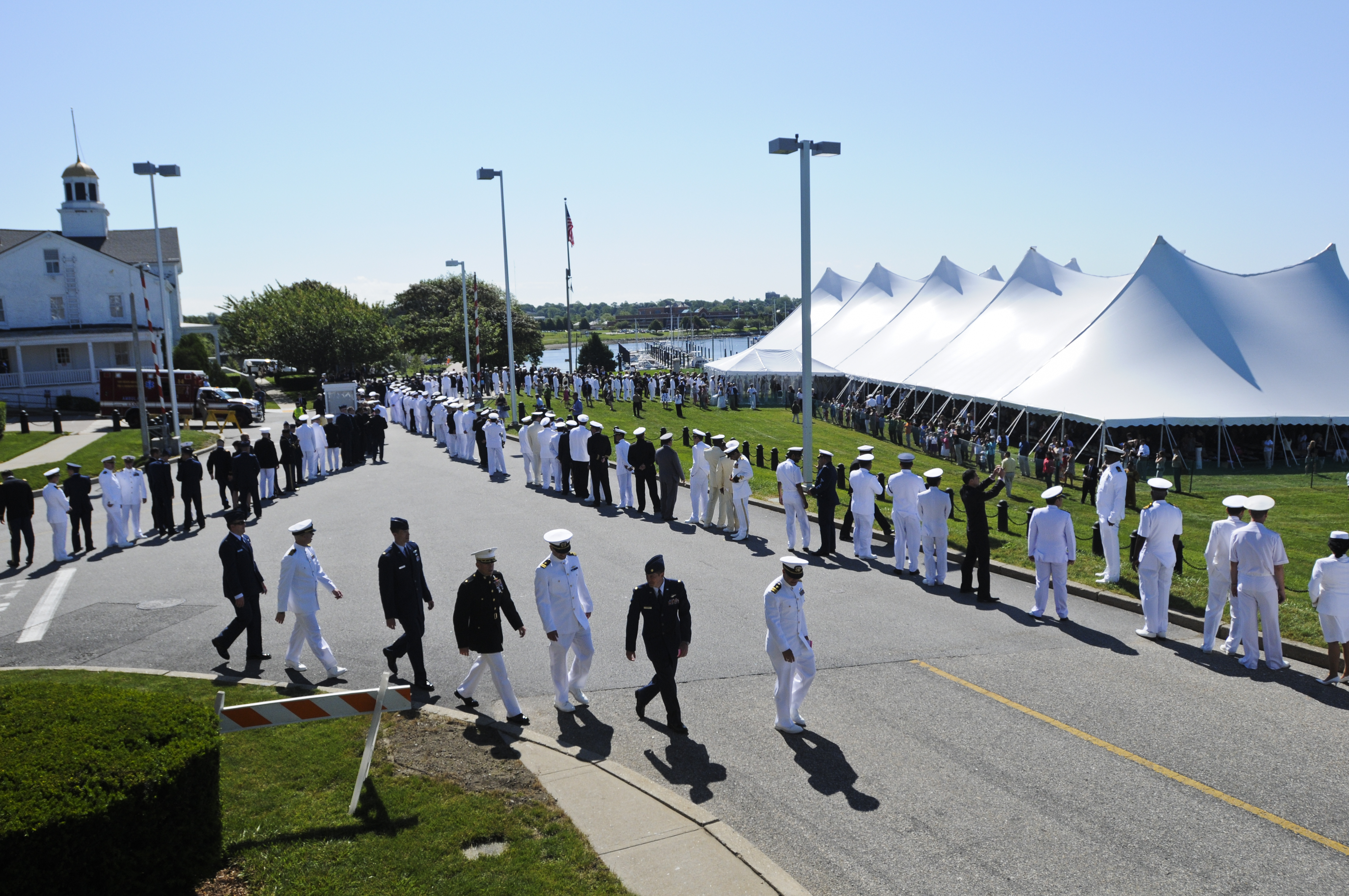 120615-N-LE393-420 NEWPORT, R.I. (June 15, 2012) U.S. Naval War College (NWC) students walk toward the graduation tent before the June 2012 graduation ceremony at the NWC. 535 students graduated today. (U.S. Navy photo by Mass Communication Specialist 2nd Class Eric Dietrich/Released)